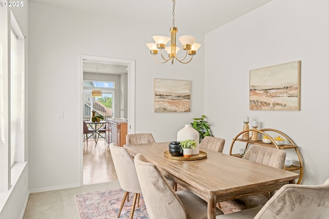 2539 NW 167th Ave, Beaverton, OR 97006 - dining area with a chandelier, light carpet, and baseboards