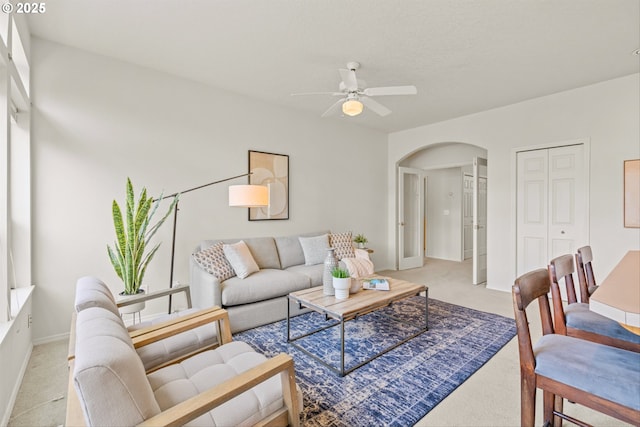2539 NW 167th Ave, Beaverton, OR 97006 - living area featuring arched walkways, light carpet, ceiling fan, and baseboards