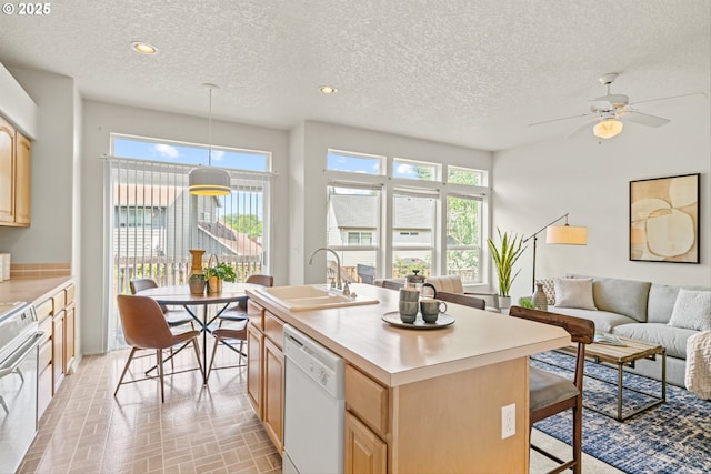 2539 NW 167th Ave, Beaverton, OR 97006 - kitchen featuring white dishwasher, a sink, light brown cabinets, stove, and a textured ceiling