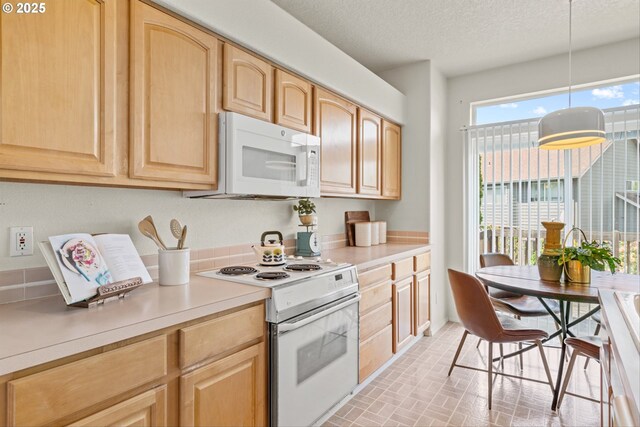 2539 NW 167th Ave, Beaverton, OR 97006 - kitchen with white appliances, light brown cabinets, brick patterned floors, light countertops, and a textured ceiling