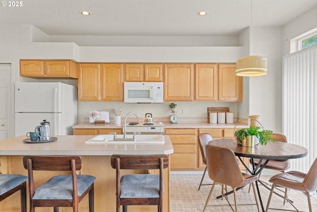 2539 NW 167th Ave, Beaverton, OR 97006 - kitchen with white appliances, light brown cabinets, light countertops, recessed lighting, and a kitchen island with sink