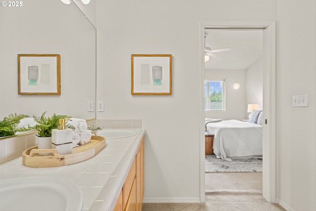 2539 NW 167th Ave, Beaverton, OR 97006 - ensuite bathroom featuring double vanity, ceiling fan, and baseboards