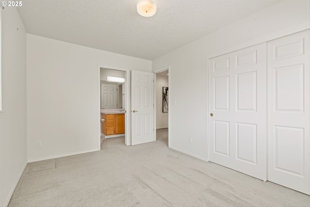 2539 NW 167th Ave, Beaverton, OR 97006 - unfurnished bedroom with light carpet, baseboards, a closet, a textured ceiling, and a wall unit AC
