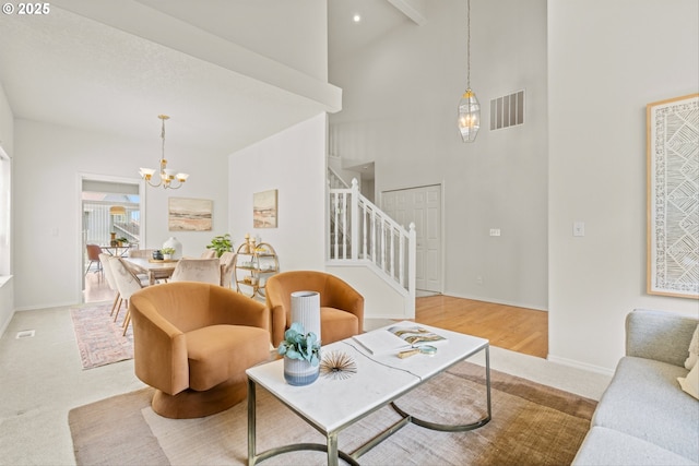 2539 NW 167th Ave, Beaverton, OR 97006 - carpeted living area with stairs, high vaulted ceiling, a chandelier, and baseboards