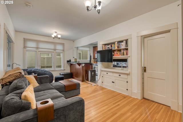 living room featuring light wood-style flooring and a chandelier