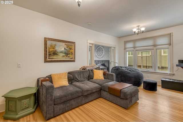 living area featuring an inviting chandelier and wood finished floors
