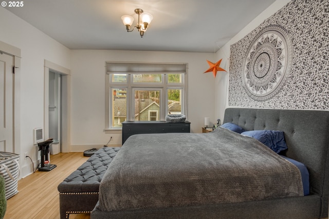 bedroom with baseboards and wood finished floors