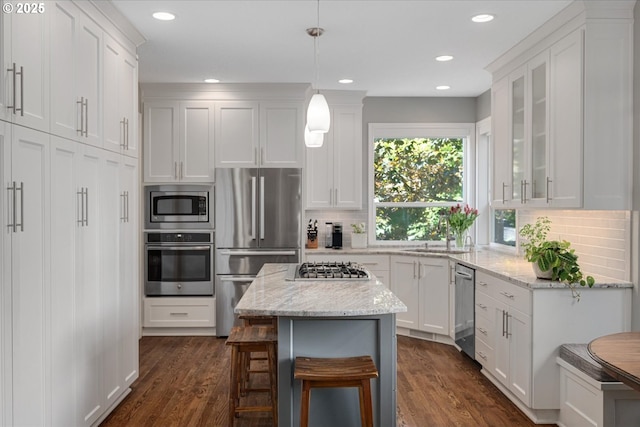 kitchen featuring stainless steel appliances, white cabinetry, dark wood-type flooring, and recessed lighting