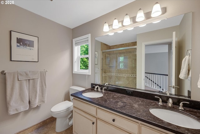 bathroom with a shower stall, toilet, double vanity, and tile patterned flooring