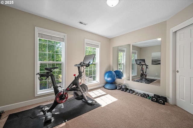 workout room with carpet and baseboards