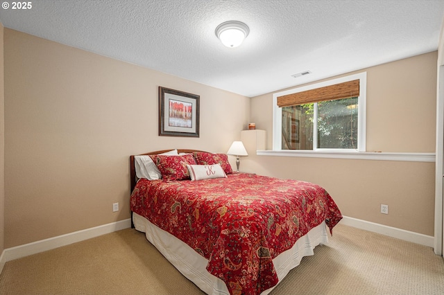 carpeted bedroom with baseboards and a textured ceiling