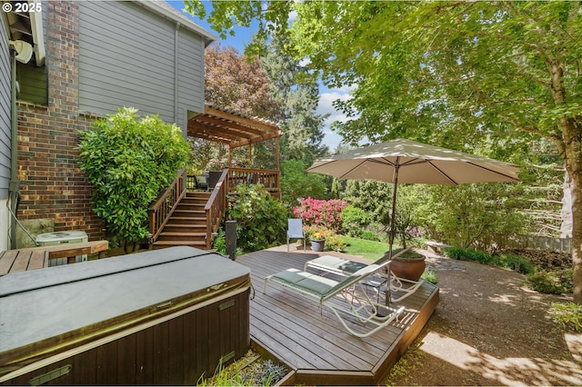 wooden deck with a hot tub, a pergola, and stairs