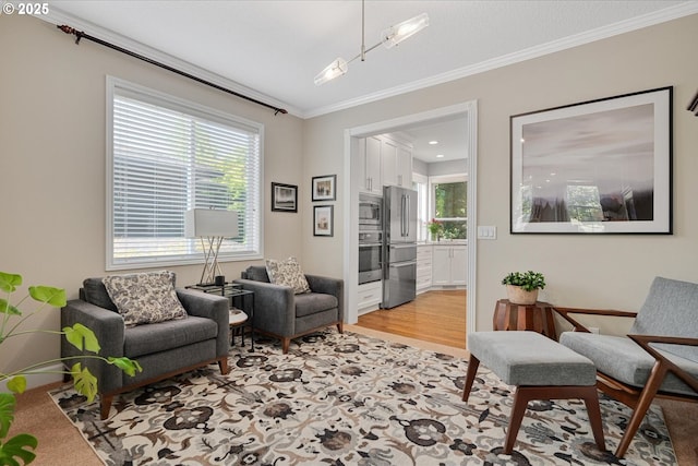 living area with ornamental molding and light wood-type flooring