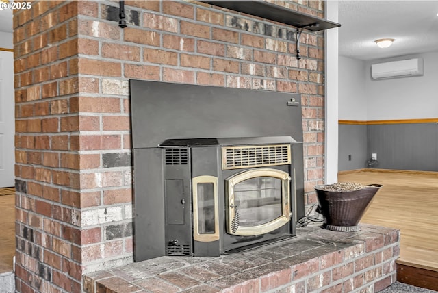 details featuring wood finished floors, a wall mounted air conditioner, and a textured ceiling