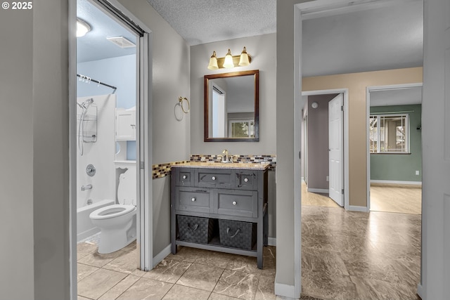 full bath featuring visible vents, toilet, a textured ceiling, shower / washtub combination, and vanity