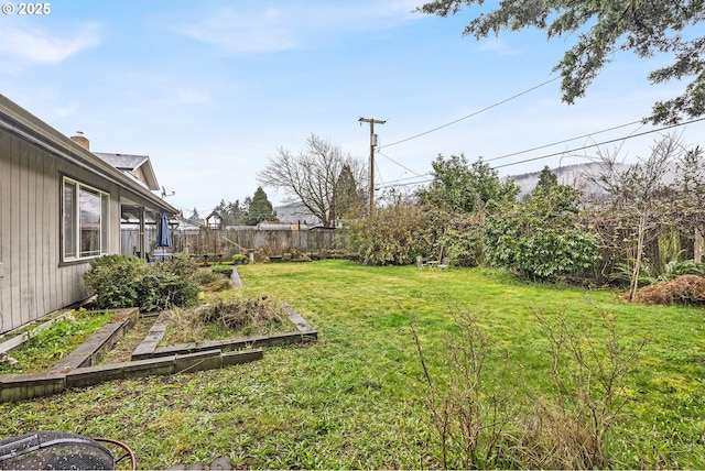 view of yard with a fenced backyard and a garden