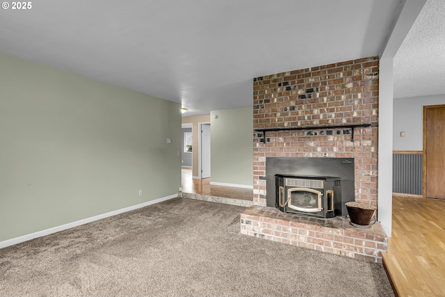 unfurnished living room featuring carpet flooring and baseboards
