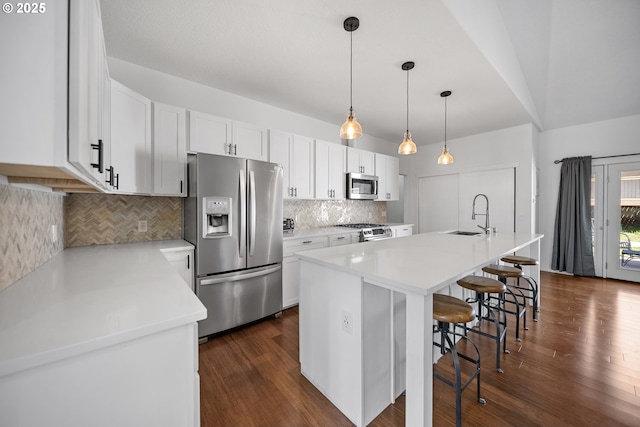 970/974 SE Roberts Ave, Gresham, OR 97080 - kitchen featuring stainless steel appliances, a sink, a breakfast bar, white cabinetry, and dark wood-style floors