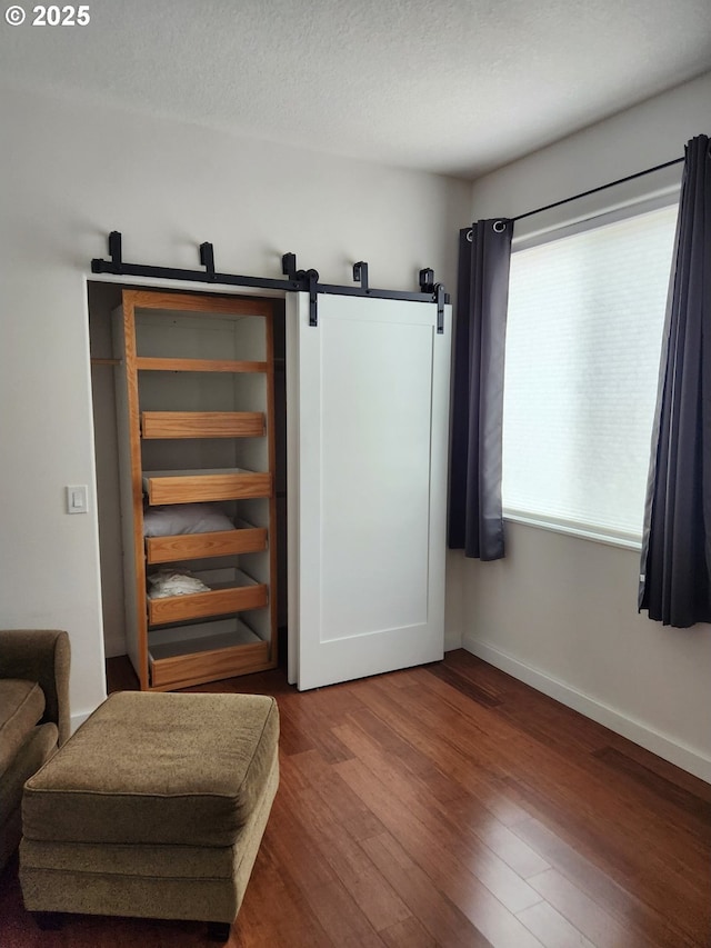 970/974 SE Roberts Ave, Gresham, OR 97080 - living area featuring wood finished floors, a barn door, and baseboards