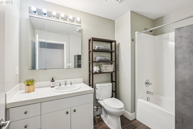 full bathroom with vanity, wood-type flooring, shower / tub combination, and toilet