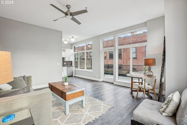 living room with ceiling fan and dark hardwood / wood-style flooring