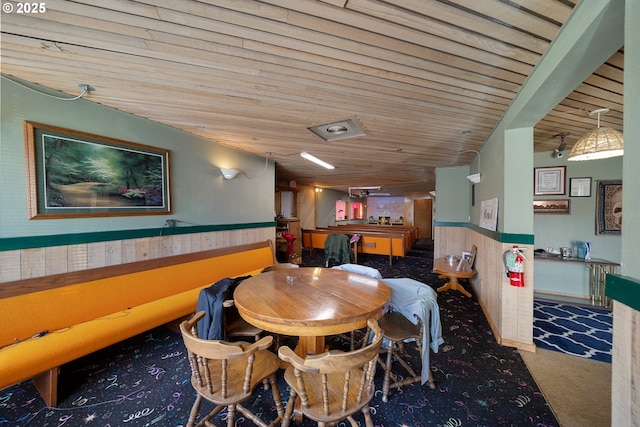 115 8th St, Winchester Bay, OR 97467 - dining room with carpet flooring, wooden ceiling, and a wainscoted wall