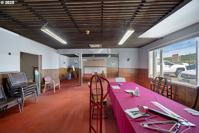 115 8th St, Winchester Bay, OR 97467 - carpeted dining room featuring wainscoting and wooden walls