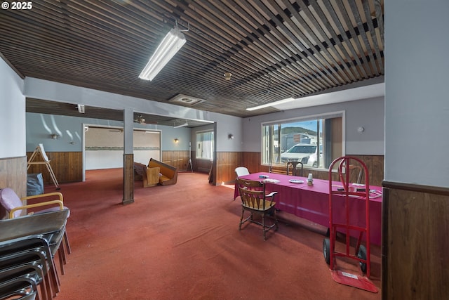 115 8th St, Winchester Bay, OR 97467 - carpeted dining area featuring a wainscoted wall and wooden walls