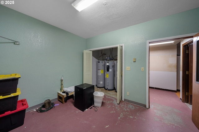 115 8th St, Winchester Bay, OR 97467 - bedroom featuring water heater, baseboards, and a textured ceiling