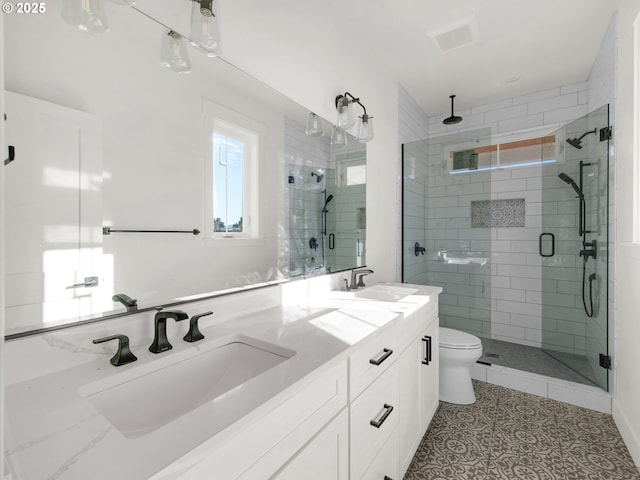 bathroom featuring vanity, tile patterned floors, toilet, and walk in shower