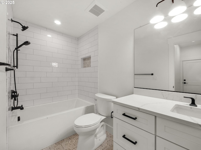 full bathroom featuring vanity, toilet, and tiled shower / bath