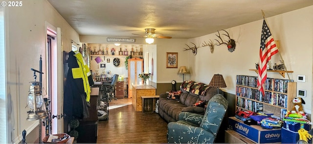 living area featuring ceiling fan and wood finished floors