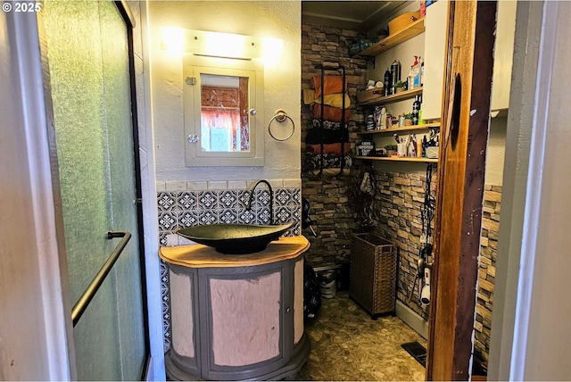 wine cellar with a textured wall, visible vents, and a sink