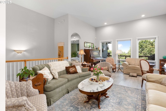 161 Single Pine Ln, Winchester, OR 97495 - living room with a towering ceiling, arched walkways, light wood-type flooring, and recessed lighting