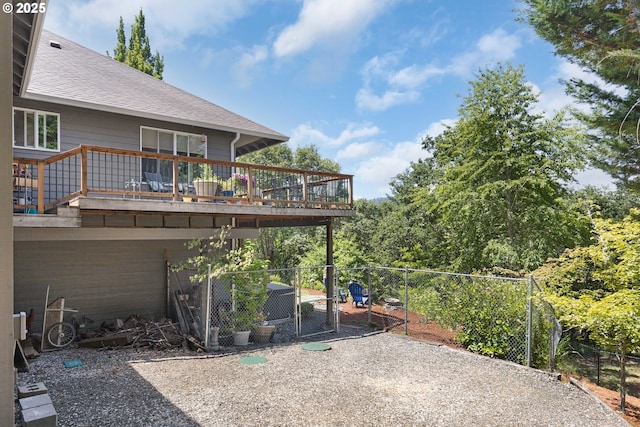 161 Single Pine Ln, Winchester, OR 97495 - rear view of house featuring roof with shingles, a wooden deck, and a gate