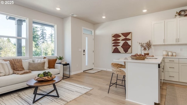 6558 SE Nasha St, Hillsboro, OR 97123 - living room featuring light wood-style flooring, recessed lighting, and baseboards