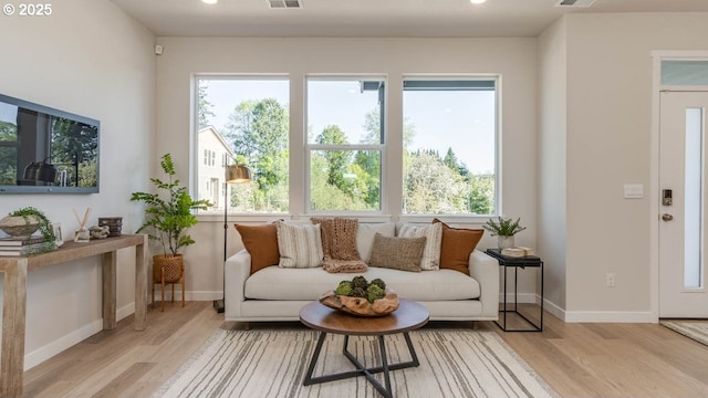 6558 SE Nasha St, Hillsboro, OR 97123 - living area featuring light wood-style floors, baseboards, recessed lighting, and plenty of natural light