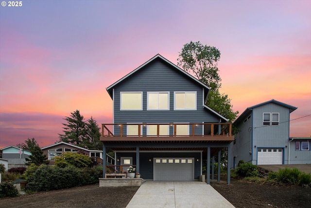 view of front facade featuring a wooden deck and a garage