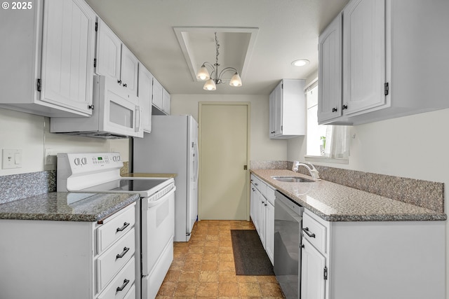 12160 SW Royal Ct Unit D, Portland, OR 97224 - kitchen featuring white appliances, white cabinets, a chandelier, stone counters, and recessed lighting