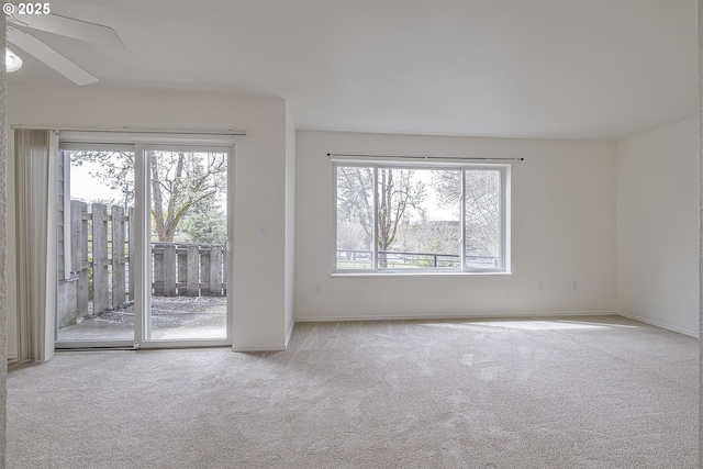7197 SW Sagert St Unit 103, Tualatin, OR 97062 - carpeted spare room featuring plenty of natural light, a ceiling fan, and baseboards