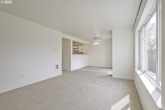 7197 SW Sagert St Unit 103, Tualatin, OR 97062 - unfurnished living room featuring carpet floors, ceiling fan, and baseboards