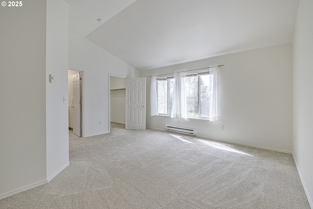 7197 SW Sagert St Unit 103, Tualatin, OR 97062 - unfurnished bedroom featuring a baseboard heating unit, light carpet, lofted ceiling, baseboards, and a spacious closet