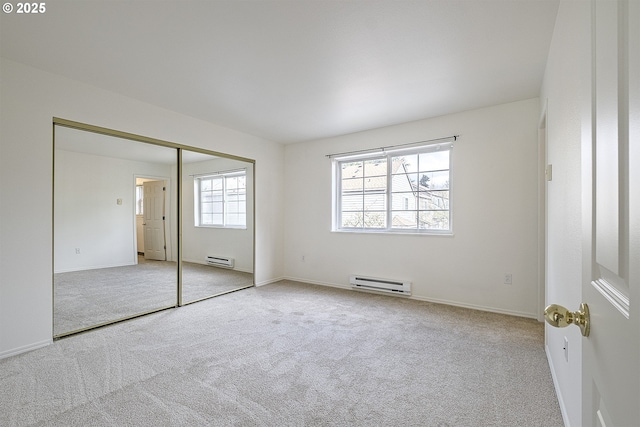 7197 SW Sagert St Unit 103, Tualatin, OR 97062 - unfurnished bedroom featuring baseboard heating, carpet, and baseboards