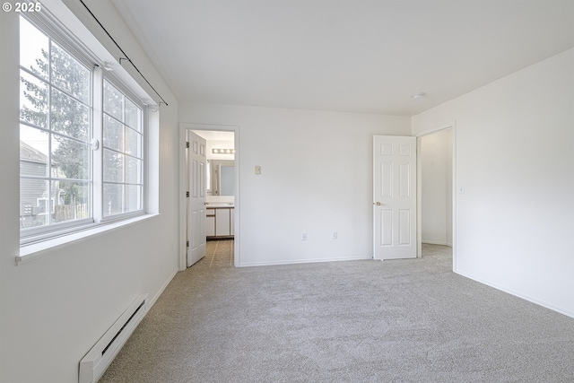 7197 SW Sagert St Unit 103, Tualatin, OR 97062 - unfurnished room with a baseboard radiator, light carpet, and baseboards