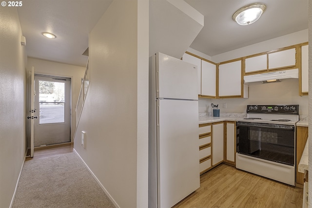 7197 SW Sagert St Unit 103, Tualatin, OR 97062 - kitchen with white appliances, under cabinet range hood, light countertops, and white cabinets