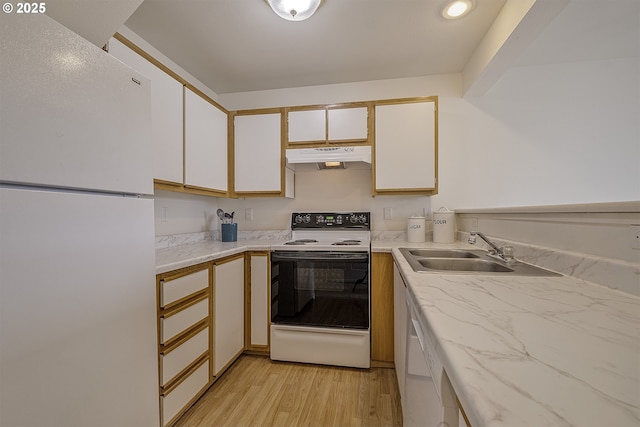 7197 SW Sagert St Unit 103, Tualatin, OR 97062 - kitchen featuring white appliances, under cabinet range hood, a sink, light wood finished floors, and white cabinetry