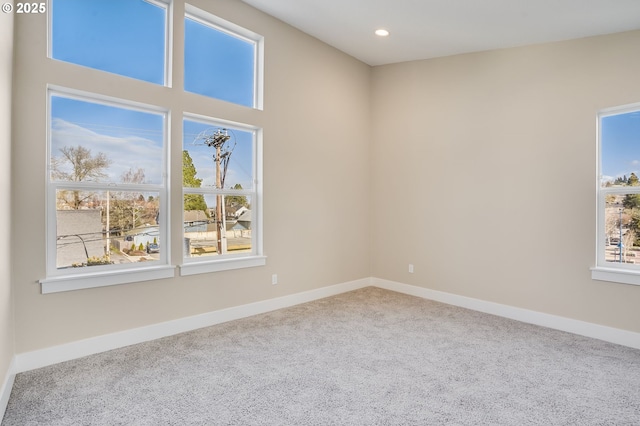 unfurnished room with carpet flooring, baseboards, and recessed lighting
