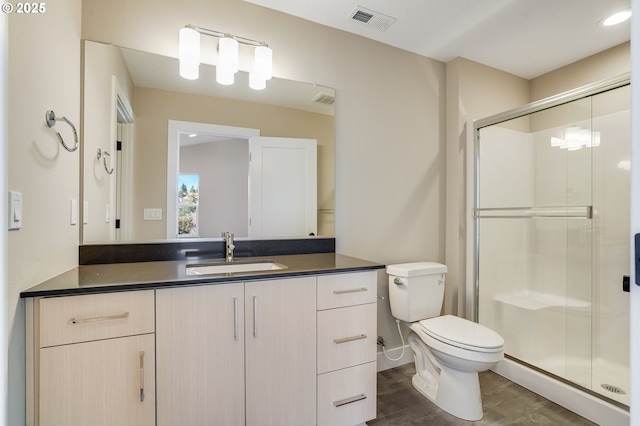bathroom featuring a shower stall, toilet, and vanity