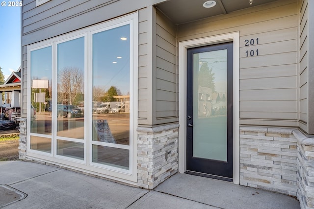 property entrance featuring stone siding