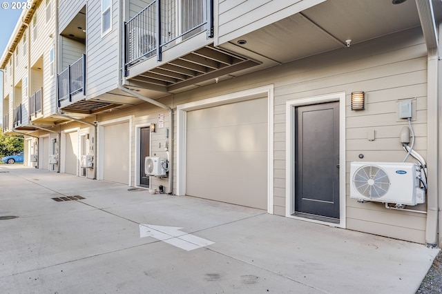 garage featuring a cooling unit, driveway, and cooling unit